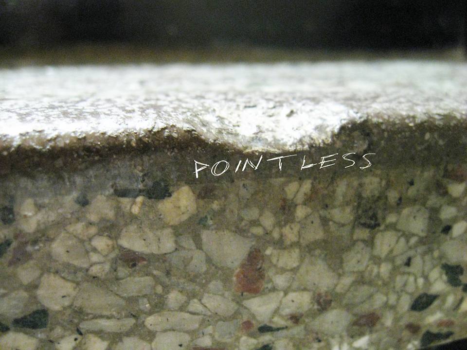 A macro photo of a stair in a school, with the word "pointless" written in all caps across it.
