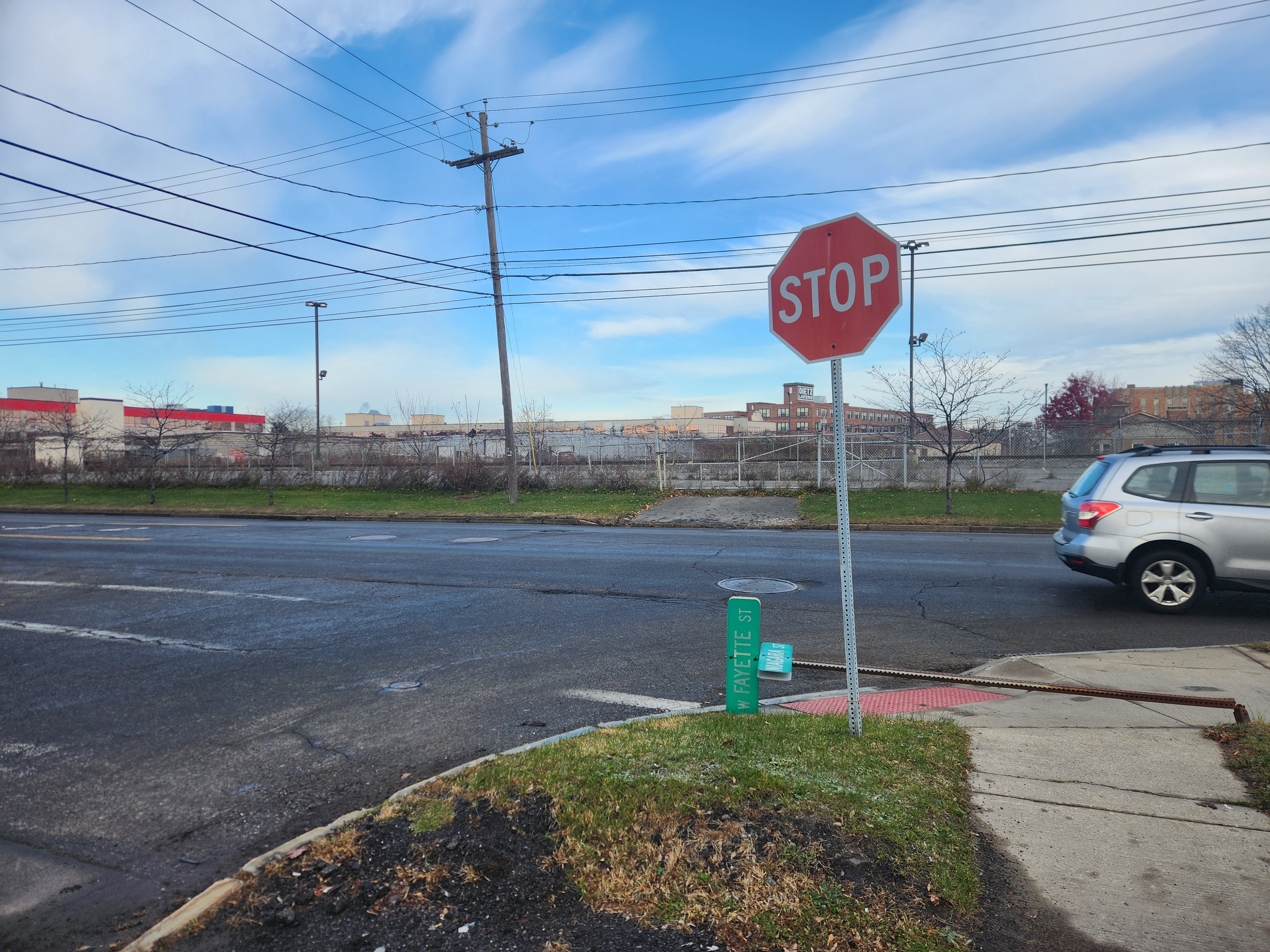 Someone knocked the street sign for the intersection of Marcellus Street and West Fayette Street over in Syracuse, New York. At least it was a sunny day.